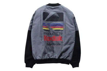Hip hop style baseball jacket in grey or white with streetwear print, round neck, and side slit pockets.