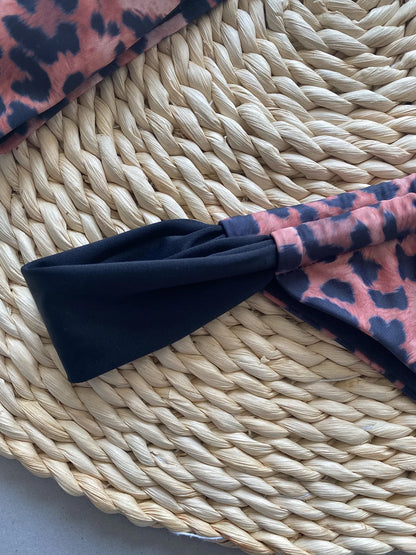 Women's black and leopard print bikini set with tube top and T-pants briefs on a mannequin.
