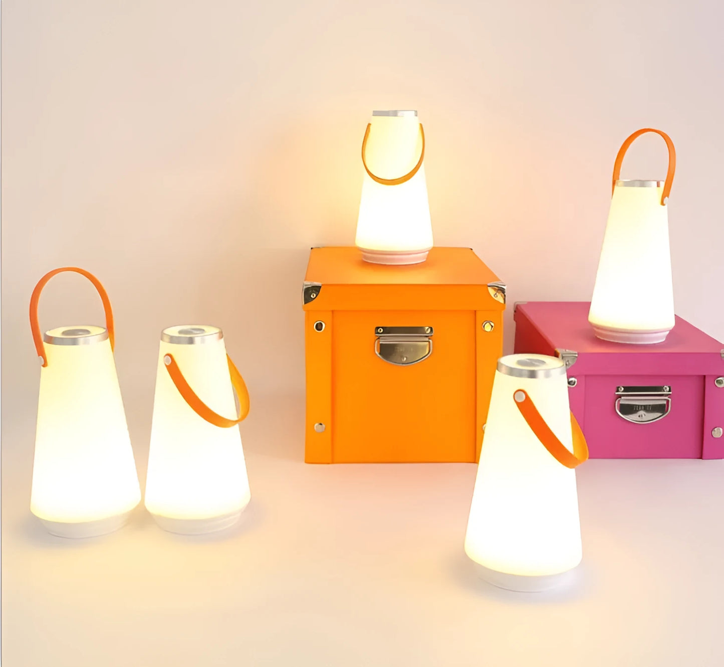 White rechargeable LED lantern with USB cable on a bedside table.
