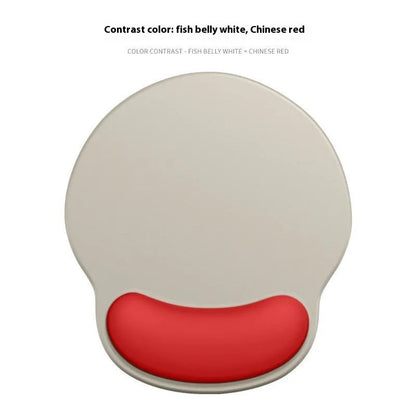 Silicone mouse mat with integrated wrist rest in a gradient blue black colour on a desk.