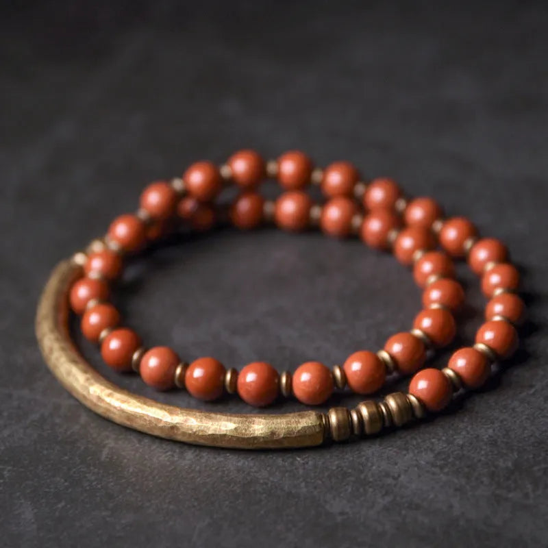 Layered stone and brass ethnic bracelet for men and women on a wrist.