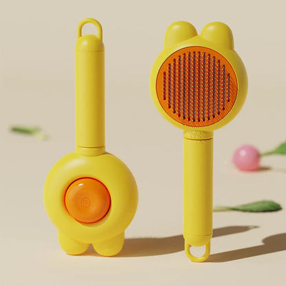 Green self-cleaning pet grooming brush with release button and stainless steel comb on a wooden table.