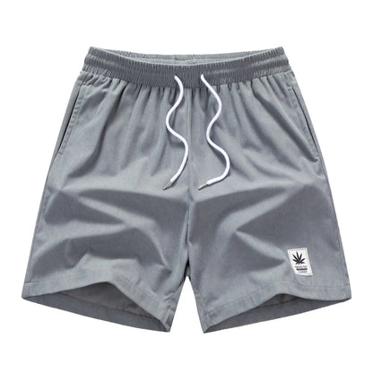 Men's straight-cut drawstring shorts in blue, shown on a model for summer casual wear.