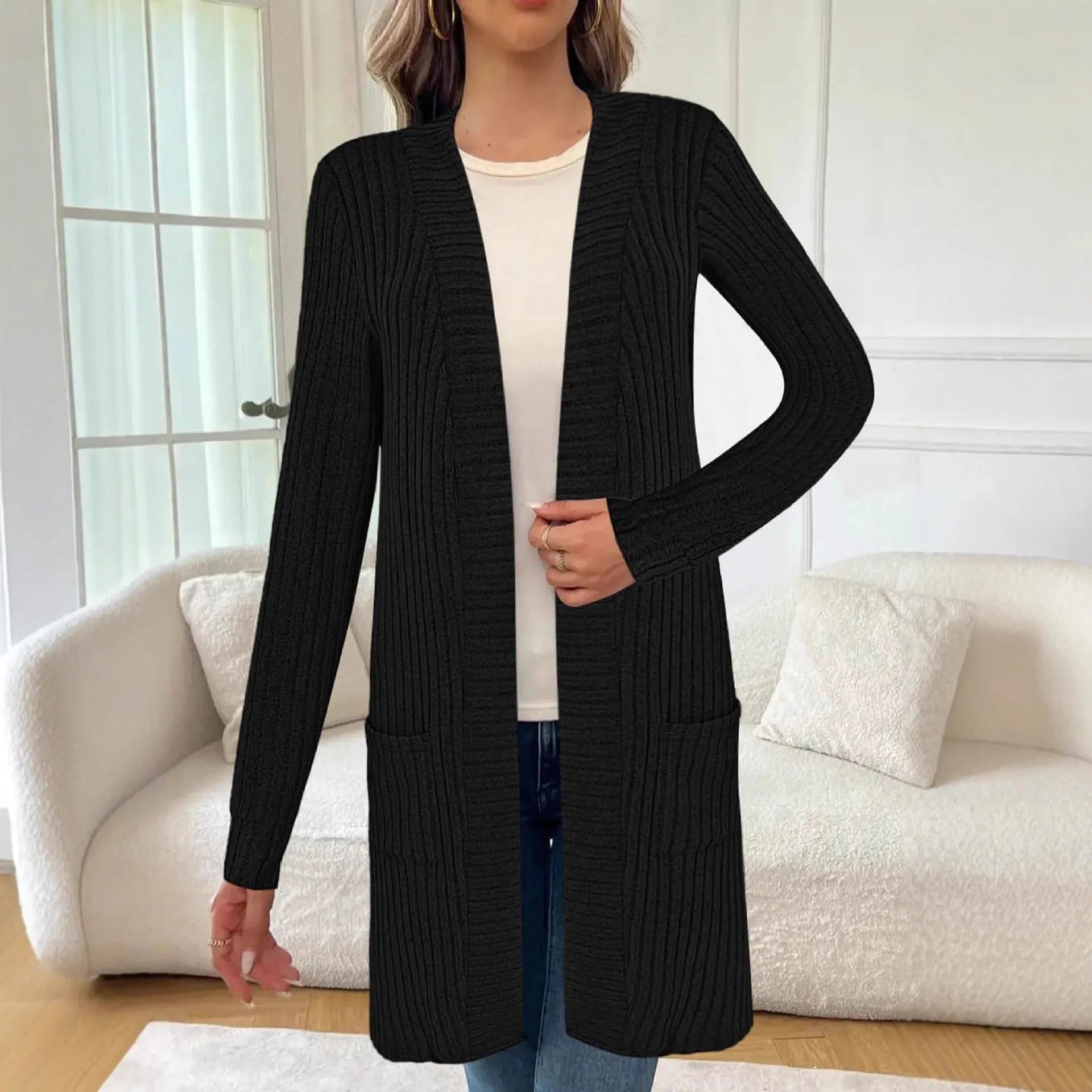 Long sleeve loose fit knitted cardigan jacket with side pockets, shown in grey.