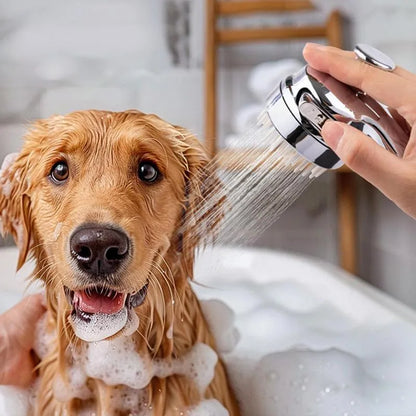 Silver dog shower attachment with integrated silicone comb and rubber grip handles.