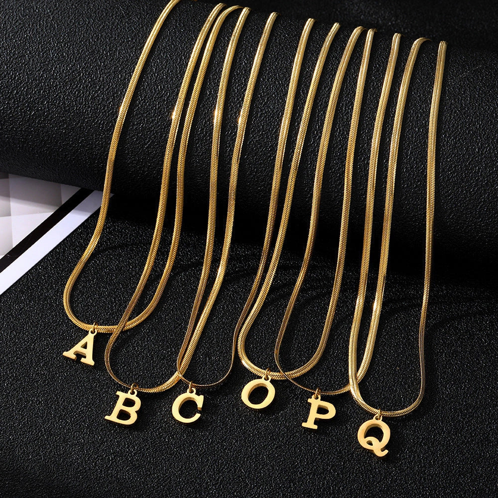 Elegant gold A-Z letter pendant necklace on a snake chain