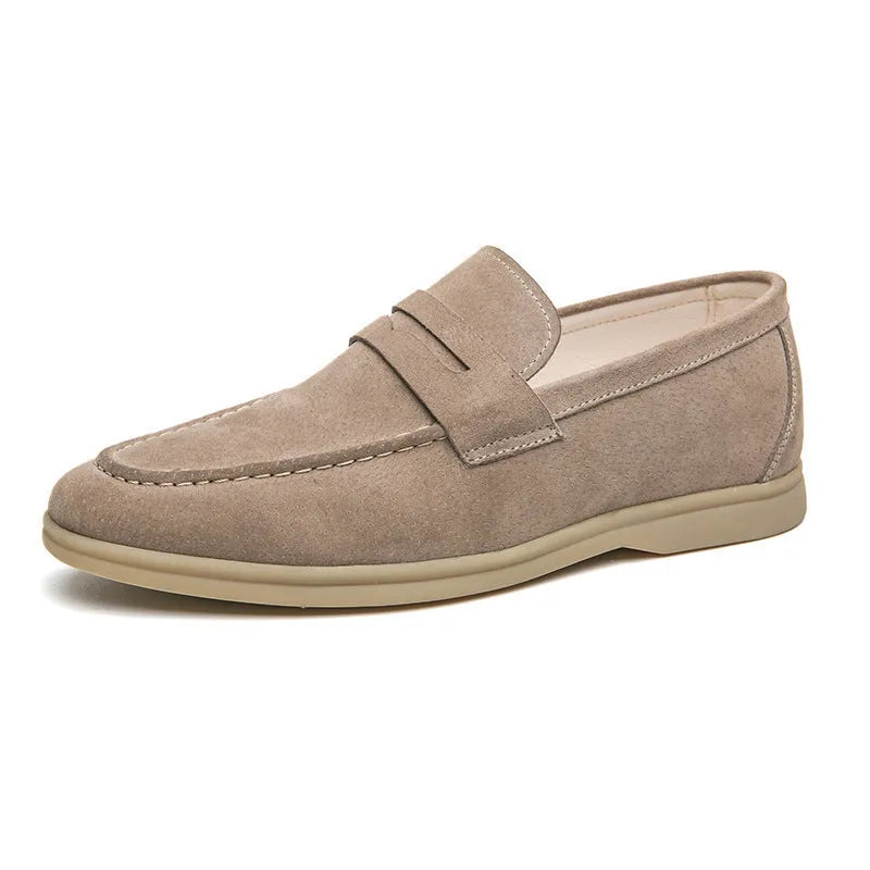 Men's beige leather slip-on shoes with a round toe and mid heel on a rubber sole.