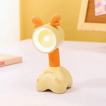Colourful cartoon character magnetic DIY night light on a desk with adjustable head.