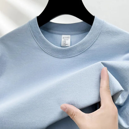 Men's thin cotton drop shoulder t-shirt on a hanger, shown in a light colour.