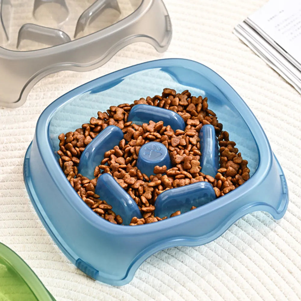 Blue plastic anti-choke slow feeder bowl for dogs on a floor