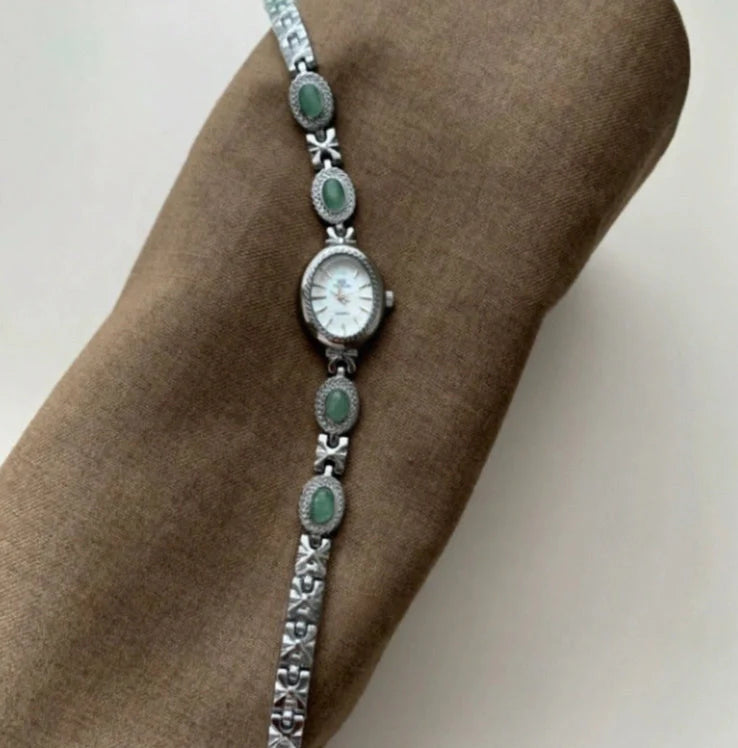 Green jade and silver ladies watch with white dial showing modern Chinese design