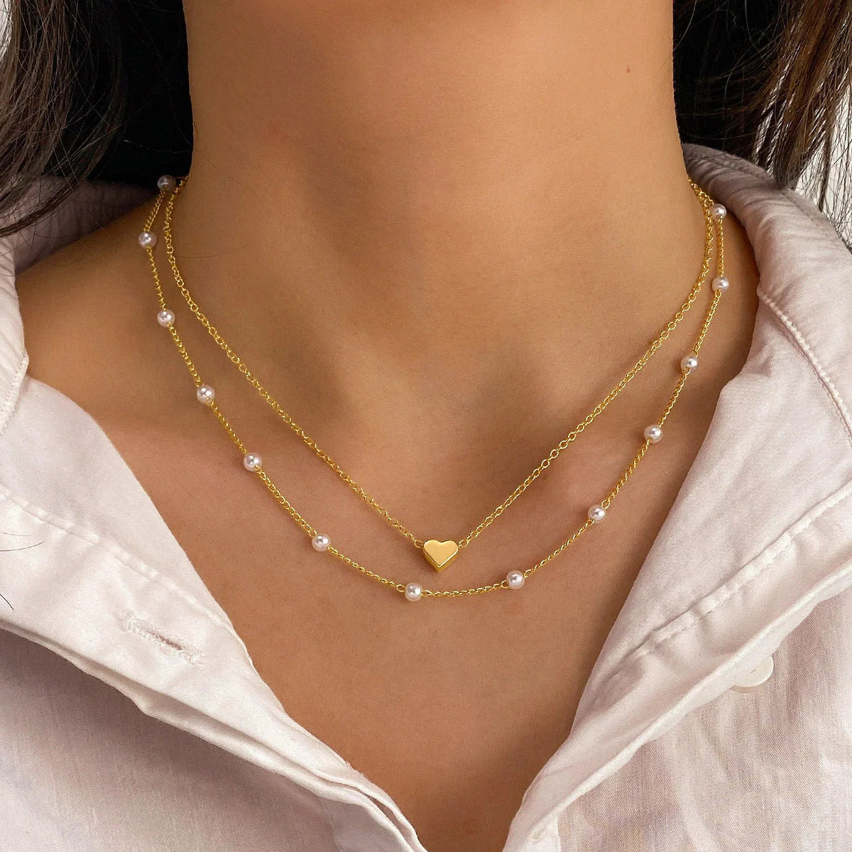 Elegant gold pearl tassel necklace with double-layered design and adjustable chain
