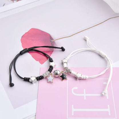 A pair of magnet couple bracelets with a suction clasp, showing various design options like clovers, crowns, and hearts.