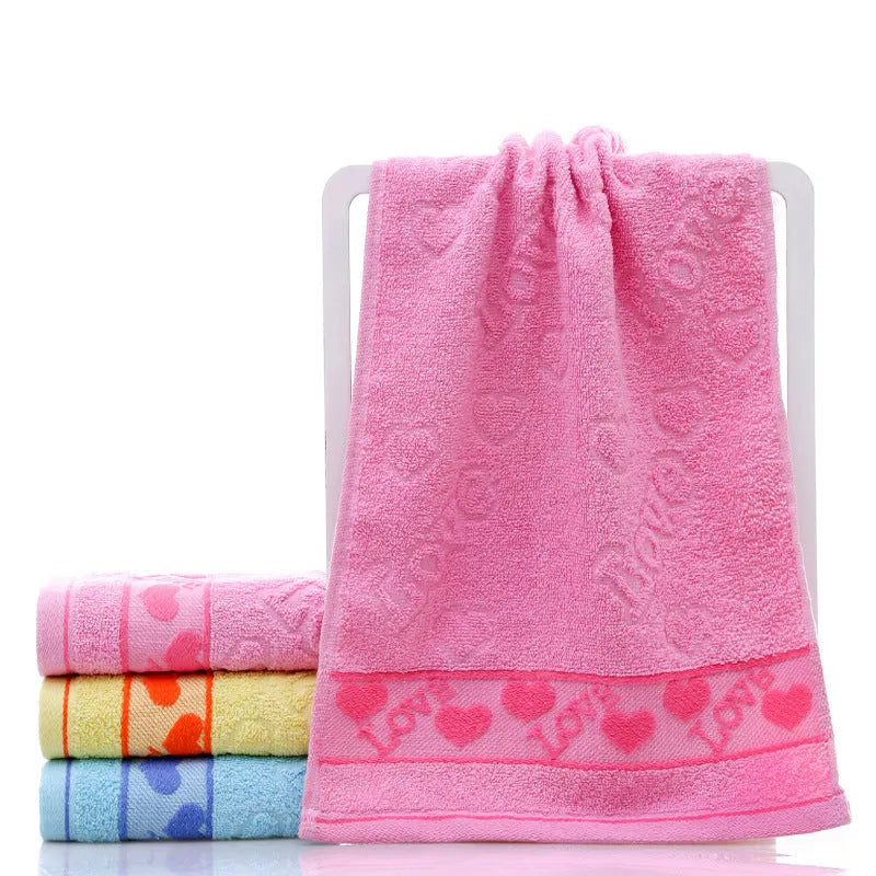 Cotton face towel in blue, pink and yellow colours with heart patterns, dimensions 73x33cm