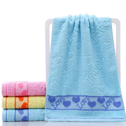 Cotton face towel in blue, pink and yellow colours with heart patterns, dimensions 73x33cm