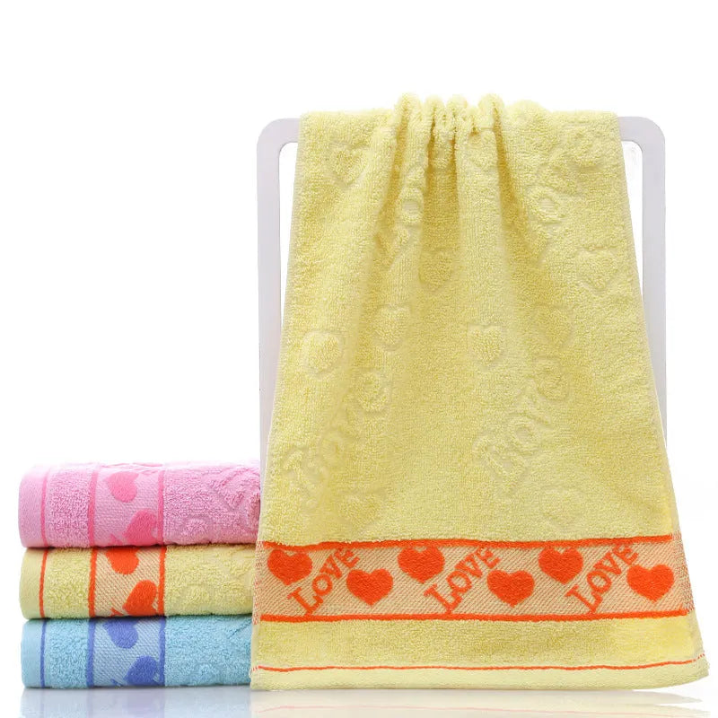 Cotton face towel in blue, pink and yellow colours with heart patterns, dimensions 73x33cm