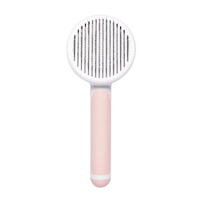 Hand-held pumpkin-coloured pet brush with stainless steel needles for grooming cats and dogs