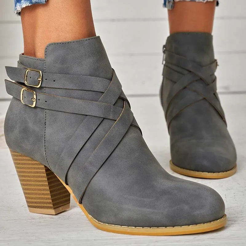 Women's short ankle boots with a belt buckle and side zip in black, brown, or grey with a 7cm heel.