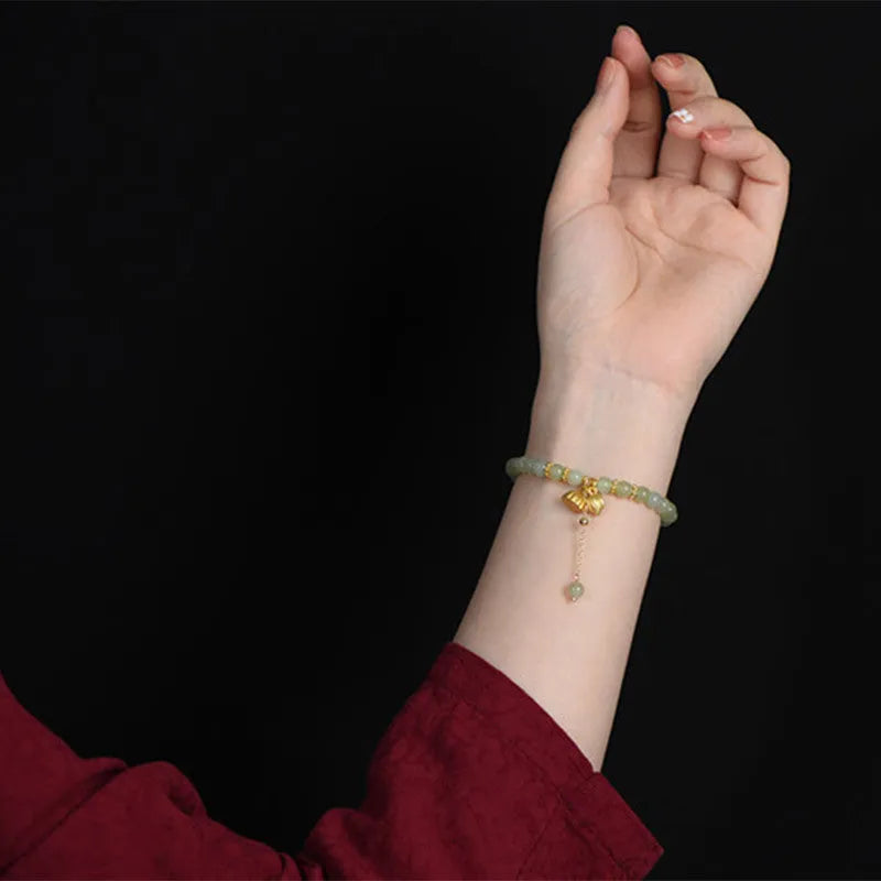 Natural Hetian jade bracelet with 6mm beads, engraved fu character, and constellation design on a simple string.