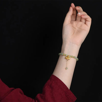 Natural Hetian jade bracelet with 6mm beads, engraved fu character, and constellation design on a simple string.