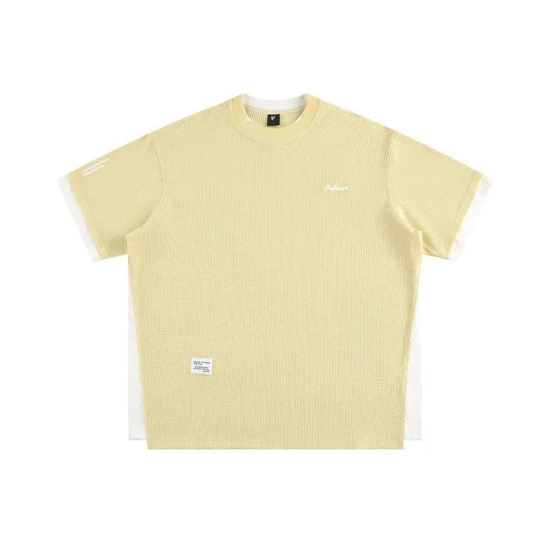 Loose fit waffle fabric T-shirt with retro alphabet embroidery on the chest, shown in navy blue.