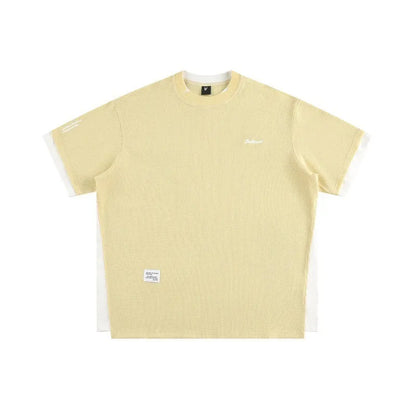 Loose fit waffle fabric T-shirt with retro alphabet embroidery on the chest, shown in navy blue.