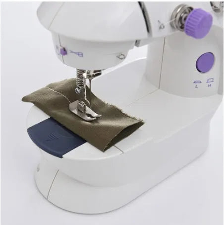 Compact white mini electric household sewing machine with work light and thread cutter.