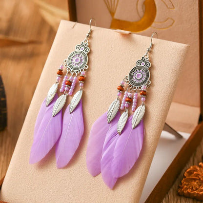 Round drop feather earrings in a bohemian leaf shape with patterned detail, shown in a light pink electroplated colour.