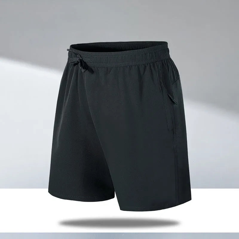 Man wearing black loose-fit quick-dry polyester sports shorts on a summer day.
