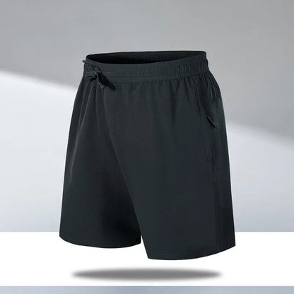 Man wearing black loose-fit quick-dry polyester sports shorts on a summer day.