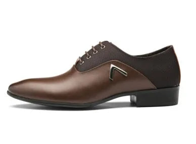 Men's black Oxford dress shoes with a classic toe cap and rubber sole, shown on a wooden floor.