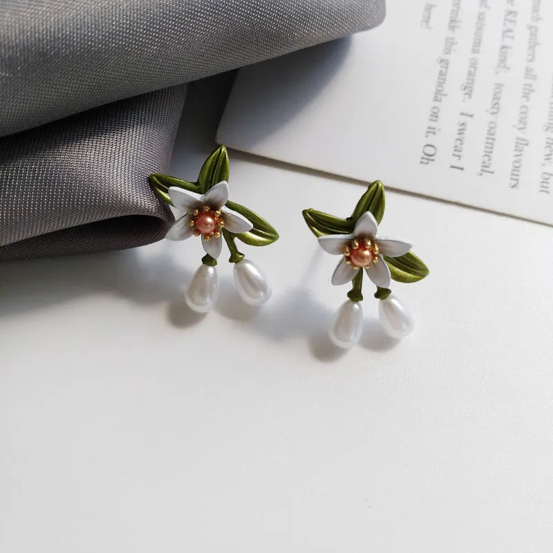 Alloy flower earring set with sterling silver needle detailing showing both stud and clip styles
