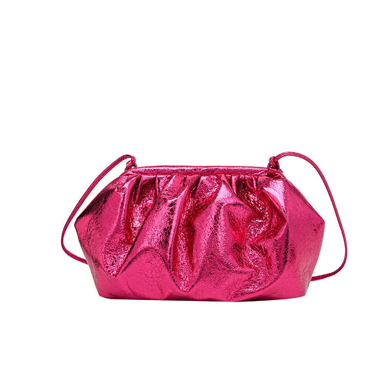 Rose red shell-shaped crossbody bag with magnetic hair clip closure and sewing line detail on the front.