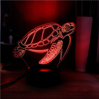 3D acrylic turtle-shaped LED night light showing one of its 16 colour options on a bedroom shelf.