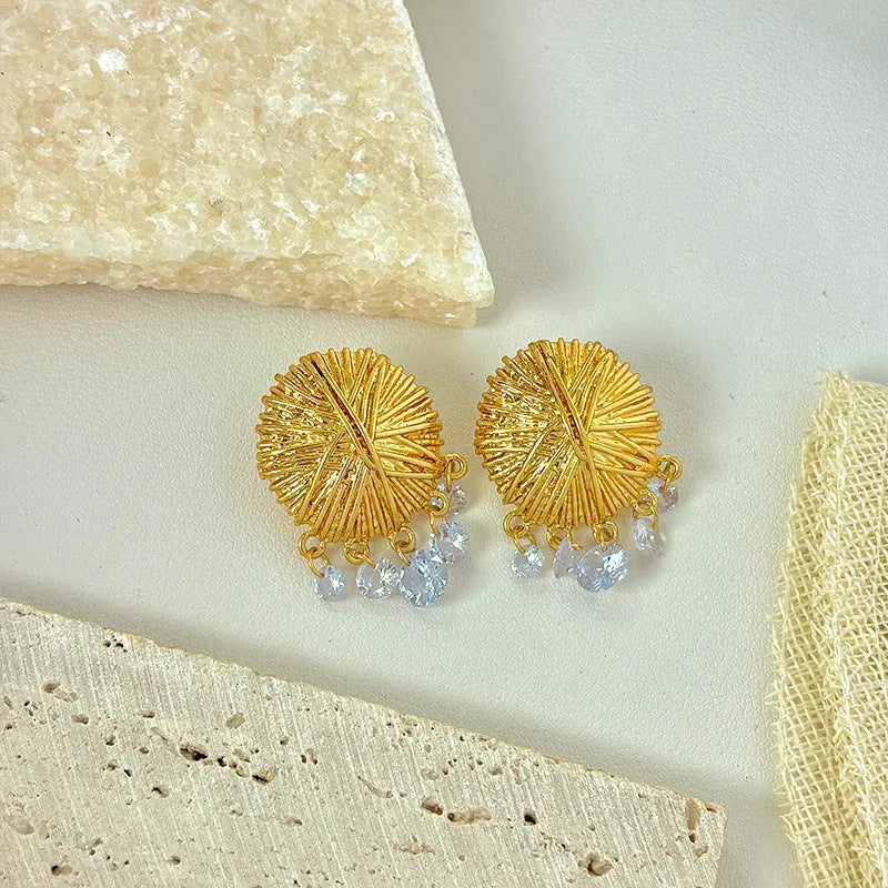 Gold geometric circle drop earrings with electroplated metal construction