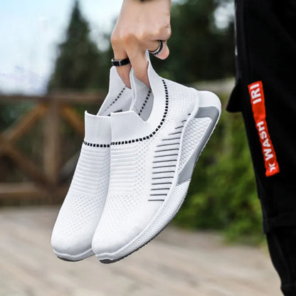 Men's black and white striped slip-on sneakers with lace-up front and mesh upper.