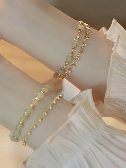 Handmade natural Hetian Jade women's bracelet in a classic beaded style.