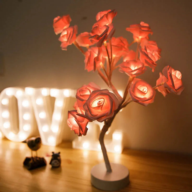 White and red rose flower LED lamp on a table with bonsai tree shape and warm white glow.