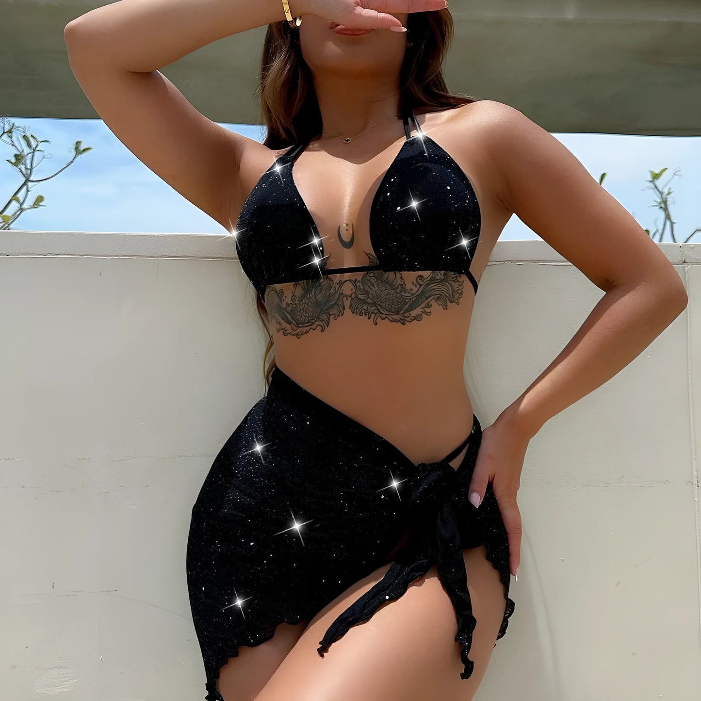 Black three-piece fission style swimsuit bikini set with top and shorts on a mannequin.