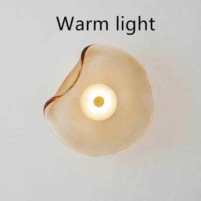 Round glass wall lamp mounted beside bed in cognac colour with 220V operation for bedside lighting