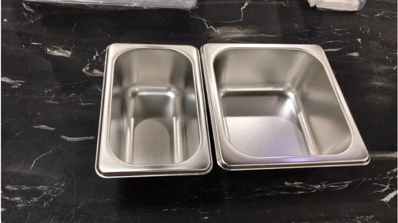 Bamboo cutting board with smooth surface alongside two large and three small plastic storage trays for vegetables and meat.