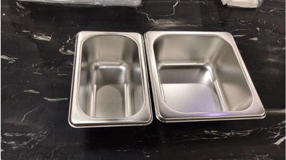 Bamboo cutting board with smooth surface alongside two large and three small plastic storage trays for vegetables and meat.