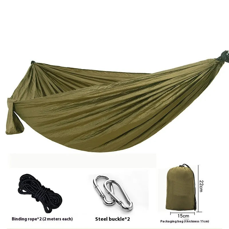 Parachute cloth double camping hammock in chosen colour, with black buckles and round ropes on a tree.