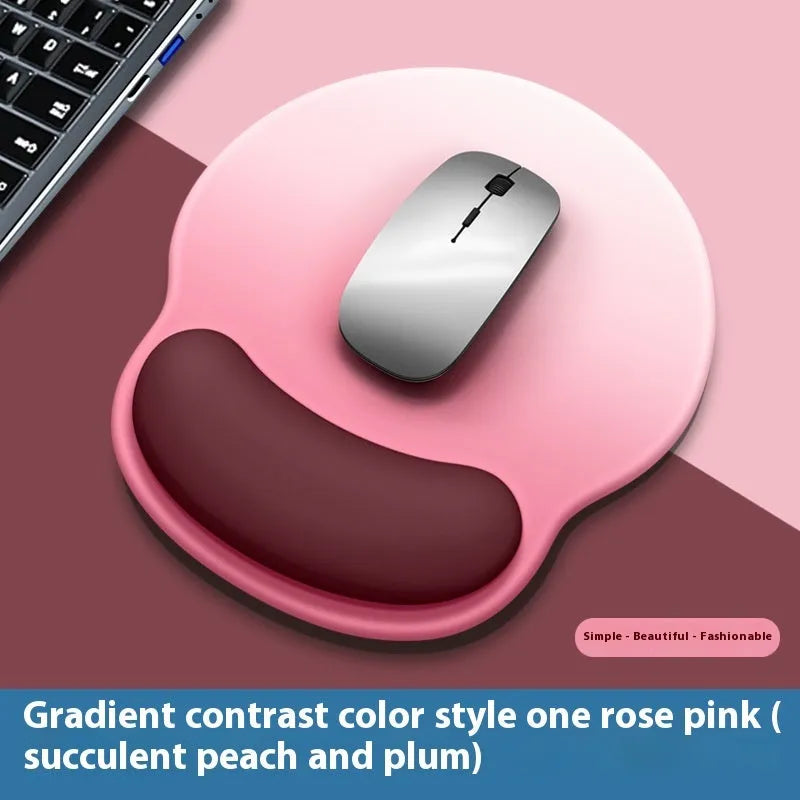 Silicone mouse mat with integrated wrist rest in a gradient blue black colour on a desk.