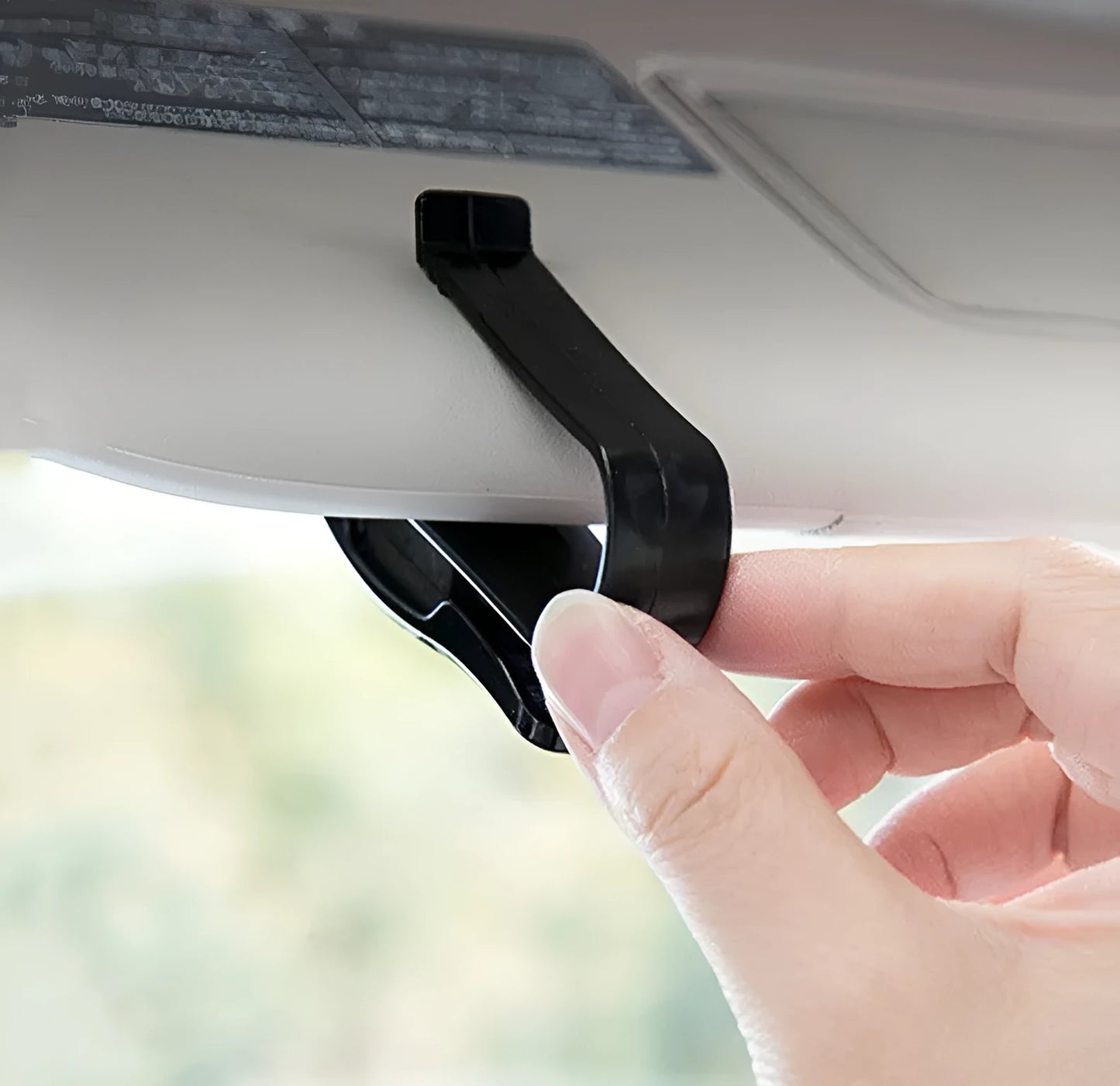 Black plastic clip for car sunshades to hold tickets, ID cards, or glasses.