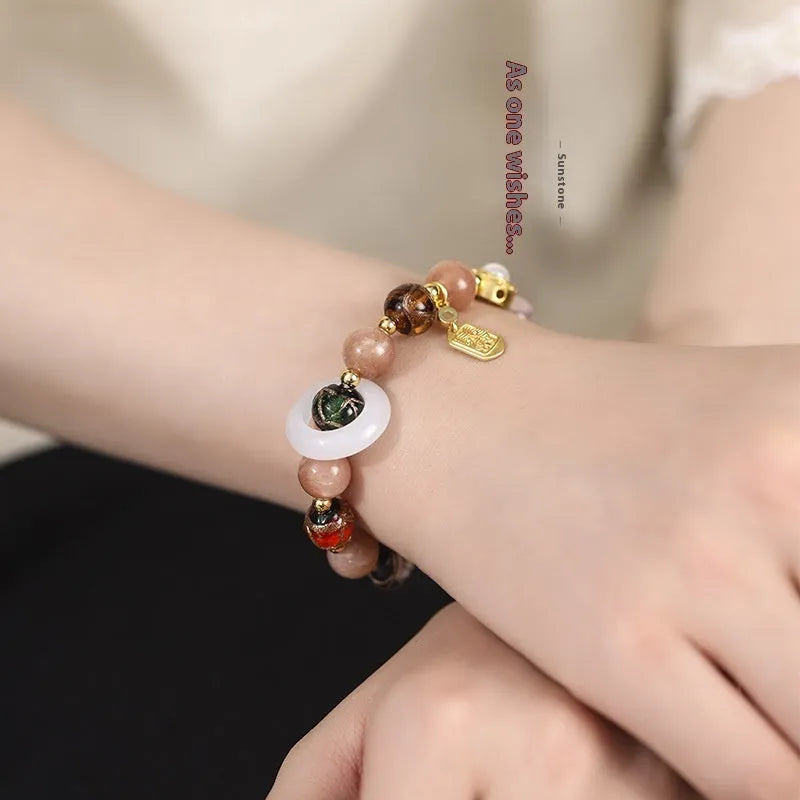 Hand-woven women's bracelet with fragrant grey coloured glaze sunstone beads, white lip shell beads, and grey glass moon charm featuring 10mm sunstone and 9mm components in a round bead design for everyday wear