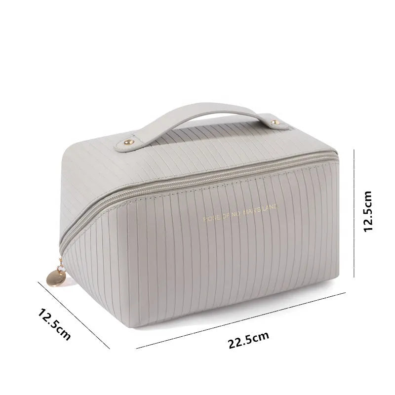 Beige cubic makeup bag with vertical pattern measuring 22.5 by 12.5 by 12.5 centimetres