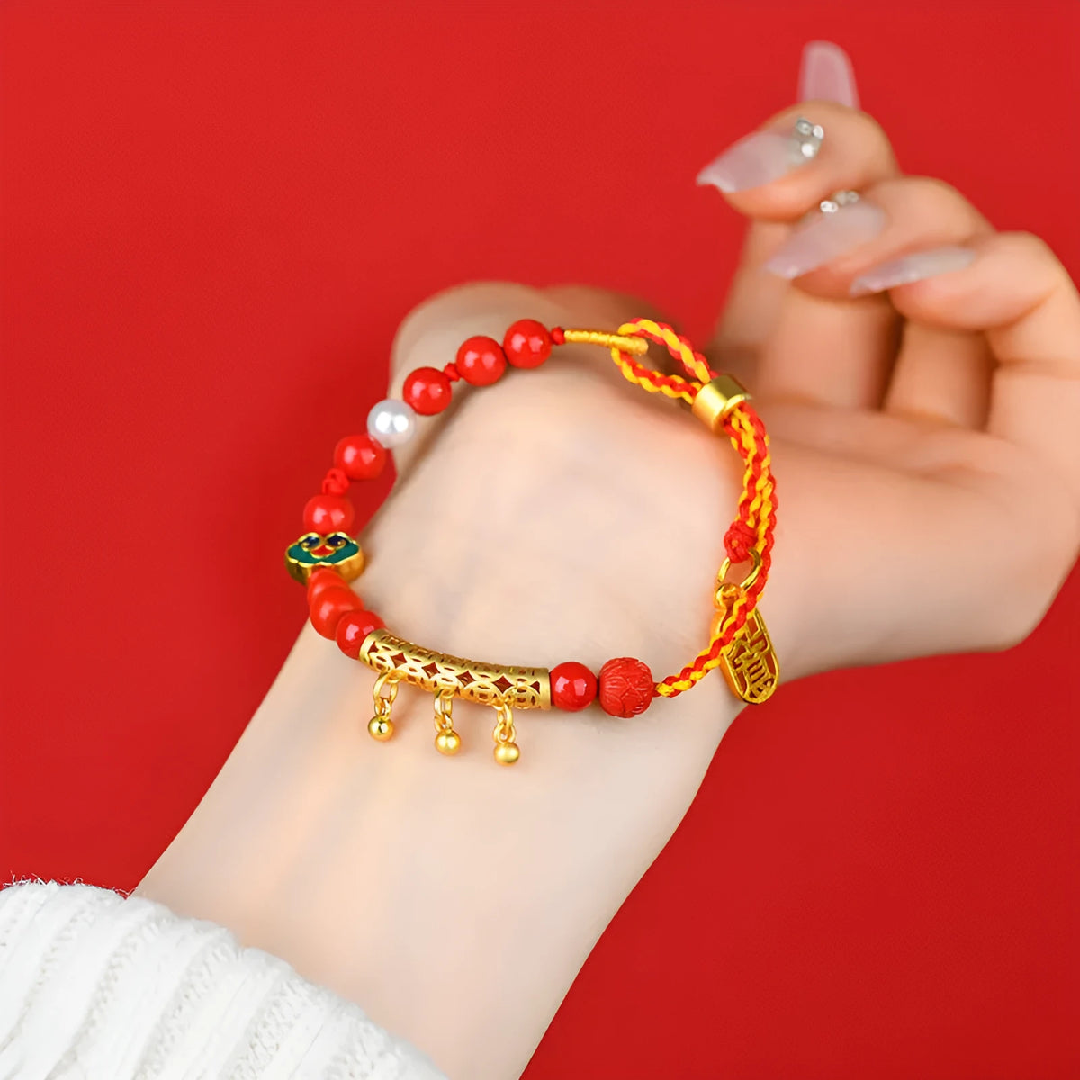 Women's hand-woven cinnabar bracelet with bell design in emperor red sand colour on red rope cord