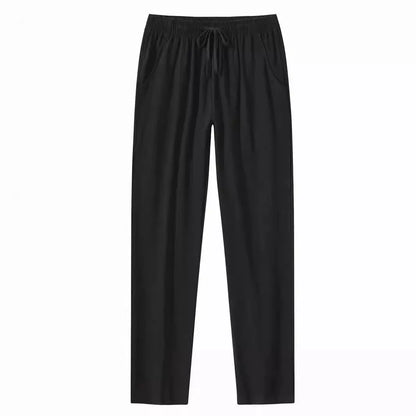 Man wearing loose-fitting cotton beach trousers in a solid colour, showcasing casual summer style.