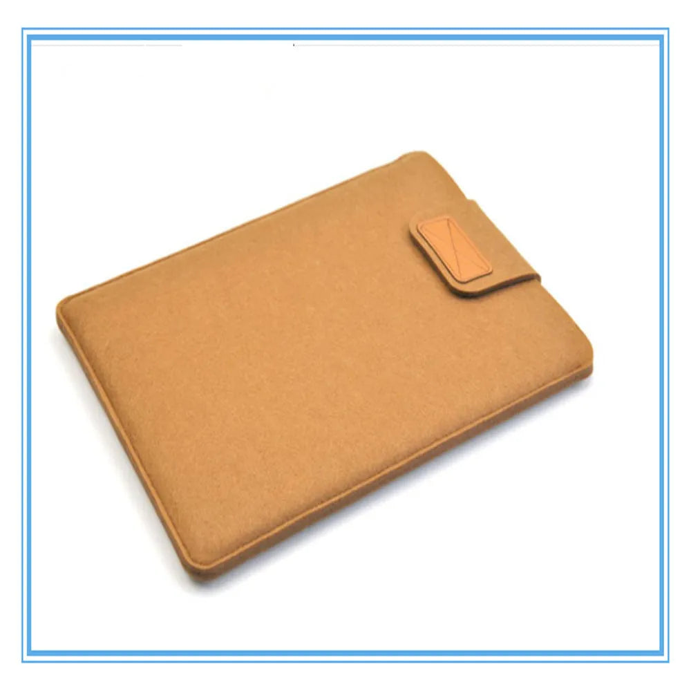 Dark grey clamshell laptop bag open to show plush internal liner and corner protectors.